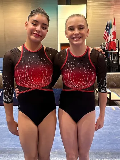 Two of our Optional Team gymnasts after a great performance at the HNI meet in Moody Gardens.