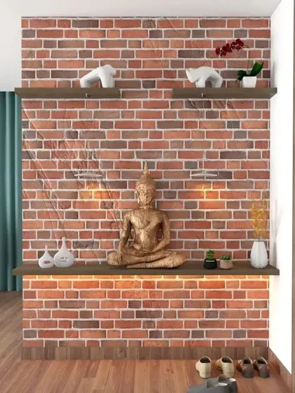We used an exposed brick accent wall to create a rustic and warm entryway. Two floating shelves provide space for a golden Buddha statue and other decor, with integrated lighting to highlight the textures and create a cozy ambiance.