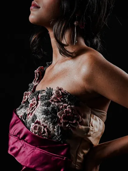 A detailed shot focusing on the intricate floral embroidery on the bodice of a custom gown. For lookbooks, I make sure to capture these close-ups that showcase the unique quality and hard work put into each piece.
