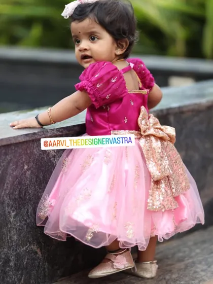 This little diva is rocking her custom pink party frock with a sequin bow. The puff sleeves add a cute touch.