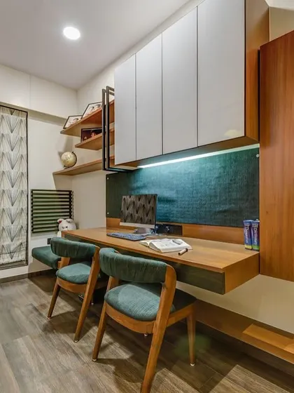 A sleek and modern study area for two. The floating desk is paired with comfortable chairs and ample overhead storage, creating a productive and clutter-free workspace.