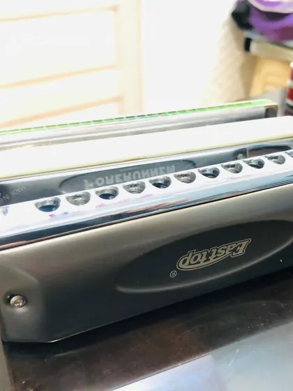 A close-up of the harmonicas used in our classes. We guide students on choosing the right type of harmonica, whether it's a diatonic or chromatic, for their musical goals.