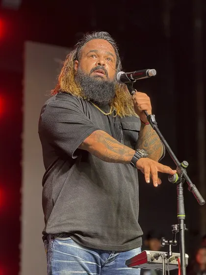 A powerful shot of our frontman on stage, embodying the passion and energy he brings to every performance.