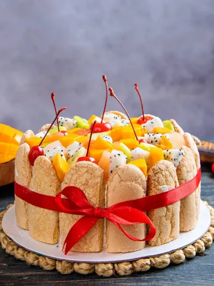 Our Exotic Fruit Cake is a fresh and vibrant option for any celebration. It's topped with a colourful assortment of seasonal fruits like kiwi, dragon fruit, mango, and cherries.