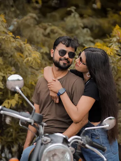 A sweet and candid close-up of the couple on a motorcycle, capturing a quiet moment of affection and their shared love for adventure.
