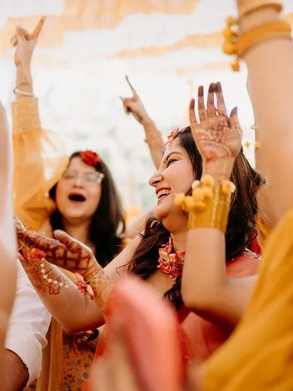 The bride and her friends dancing in a circle, a moment of shared joy and celebration.
