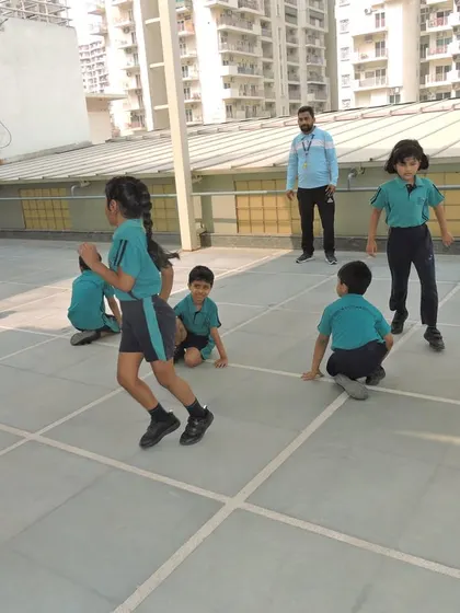 An action shot capturing the agility and focus of a student during an inter-house Kho-Kho match.