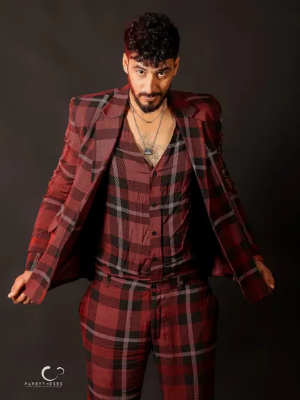 A confident pose that showcases the full suit in a dynamic way. The open jacket adds a sense of movement and style.