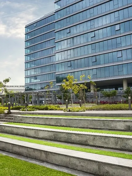 Tiered landscape seating at the Godrej Centre Development provides an outdoor amphitheater for employees. This feature encourages informal gatherings and relaxation, extending the workspace into the natural environment.