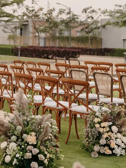 The aisle is lined with beautiful, rustic floral arrangements.