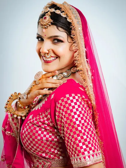 A happy and radiant bride in our pink Marvadi lehenga. This is the look of joy I love to help create.