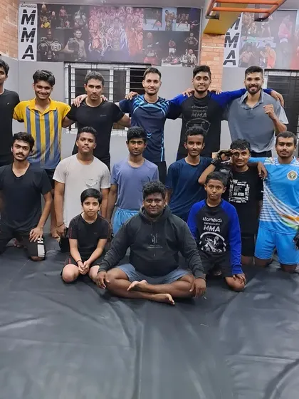No fear in our dojo. Our grappling team poses with their coach, embodying the confidence and skill built on the mats.