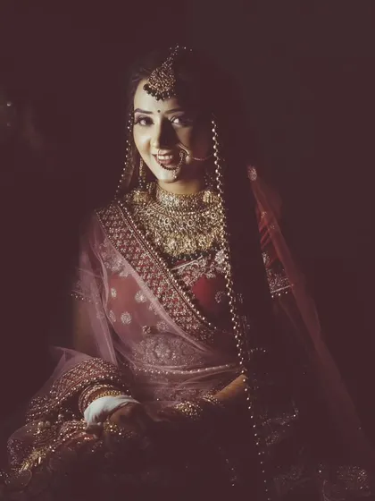 A moody and atmospheric portrait of a bride, using shadows and a single light source for a dramatic effect.