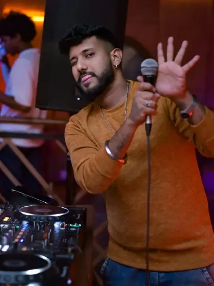 I do more than just play music; I connect with the crowd and keep the energy high all night. Here I am on the mic, making sure everyone is part of the experience.