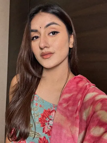 A simple, beautiful selfie in a floral print suit with a pink dupatta and a bindi. Just a quiet moment capturing a traditional aesthetic.