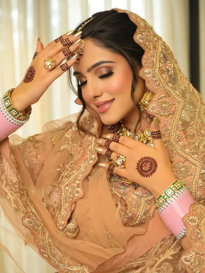 A candid moment that captures the bride's happiness. The makeup looks fresh and natural, even in bright light.