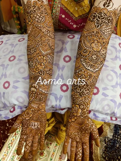 A very dense and detailed bridal design, perfect for the bride who wants maximum coverage. The patterns are a mix of floral, paisley, and geometric shapes, creating a rich and textured look.