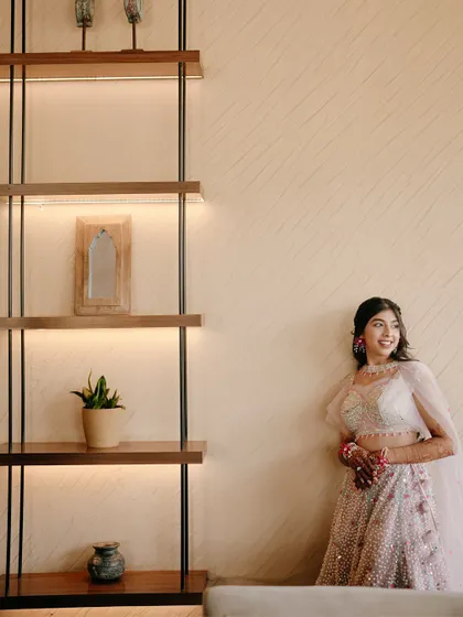 A smiling portrait of the bride against a modern, well-lit interior. Her happiness shines in this beautifully composed shot.