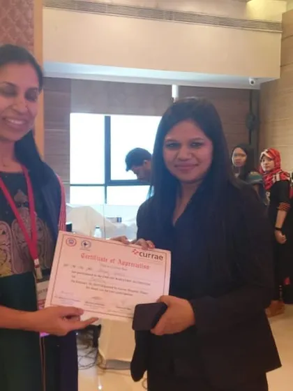 Receiving a certificate of appreciation at a Currae event for my contributions to bariatric nutrition education and patient care.