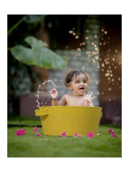 A playful splash in the tub! These action shots are full of energy and capture the fun-loving spirit of childhood.