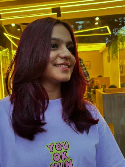 This client's Malbec hair color is styled straight with soft layers, showing off the dramatic yet classy look.