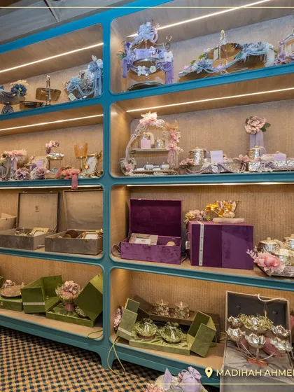 The display shelves at the Ahmedabad store, showcasing a variety of hamper styles in different color palettes, from soft pastels to rich jewel tones.