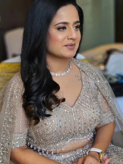A candid shot of the bride-to-be. The makeup is subtle enough to let her natural beauty shine through.