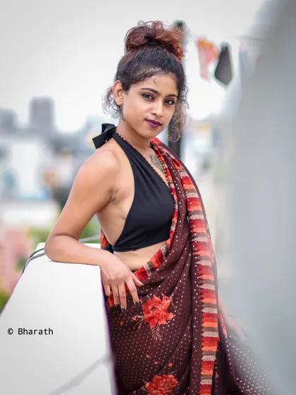 A confident and stylish pose, this rooftop portrait combines traditional attire with a modern, urban attitude.