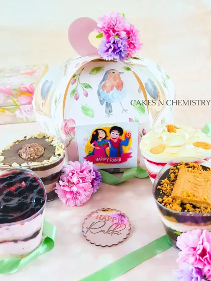 A beautiful Rakhi gift hamper featuring an assortment of my dessert jars. These single-serving treats come in a variety of flavours like Blueberry, Lotus Biscoff, and Ferrero Rocher, all packed in a lovely gift box.