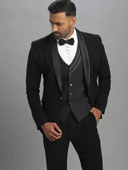 A full studio shot of the black embroidery designer suit. This pre-loved piece offers a complete, polished look for any man wanting to make a statement.