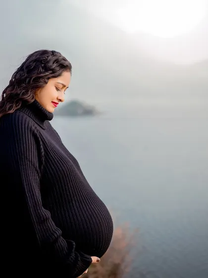 A solo portrait of the mother-to-be, gazing at her bump against the vast, misty lake. This is a powerful and contemplative image of motherhood.