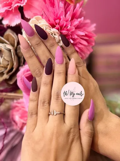 Are you a purple fan? This stunning set features long, matte stiletto nails in various shades of pink and purple for a chic, multi-tonal look.