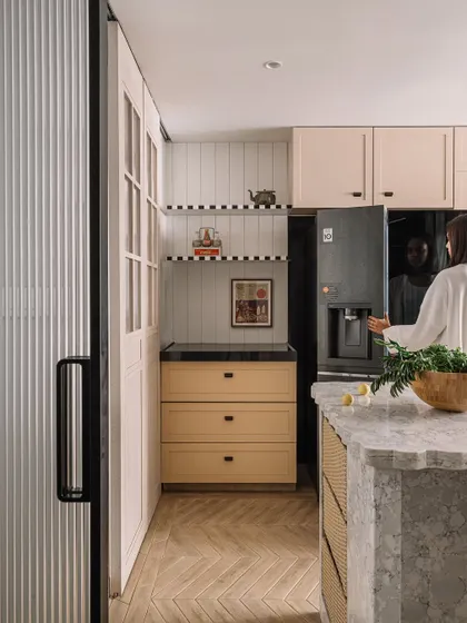 The spacious kitchen at Kanso House, showing the island and ample storage. The design balances low-maintenance materials with elegant finishes.