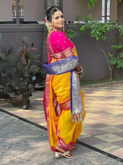 A side profile of the Brahmani Navari drape, showing the unique way the pleats are tucked at the back. This style is known for its comfort and elegance, making it a popular choice for wedding ceremonies.