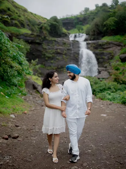 Walking hand-in-hand, this shot captures the couple's journey together against a beautiful, natural landscape.