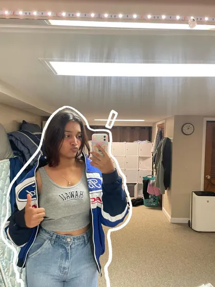 A basement mirror selfie with a simple white outline.