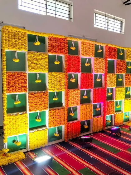 A wide shot of the marigold backdrop for the ceremony.