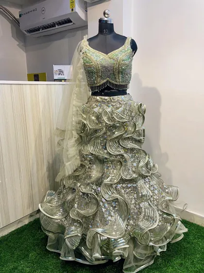 Another view of the stunning green ruffled gown-style lehenga, perfect for making a grand entrance at any evening event.