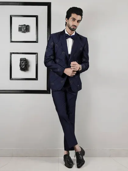 The full view of our expertly tailored navy tuxedo. The subtle grid pattern and delicate embellishments offer a modern twist on a classic silhouette.