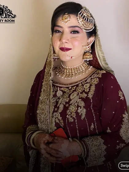 This bride is ready for her Nikah ceremony. The makeup features a classic winged liner and a deep berry lip, paired with traditional jewellery.