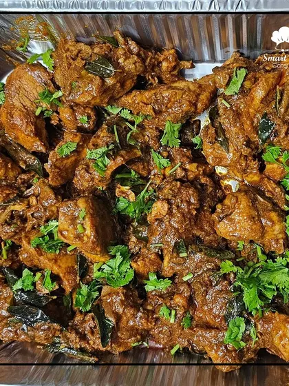A tray of spicy and aromatic chicken curry, a classic main course dish that pairs perfectly with rice or naan.