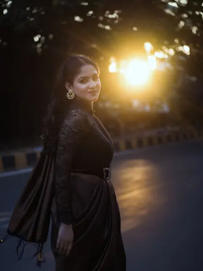 A beautiful solo portrait of the bride-to-be on a city street at sunset. The golden hour light creates a beautiful flare and highlights her elegant silhouette.