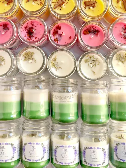 A closer look at the different styles in the wedding order, including pink candles with rose petals and green layered candles.