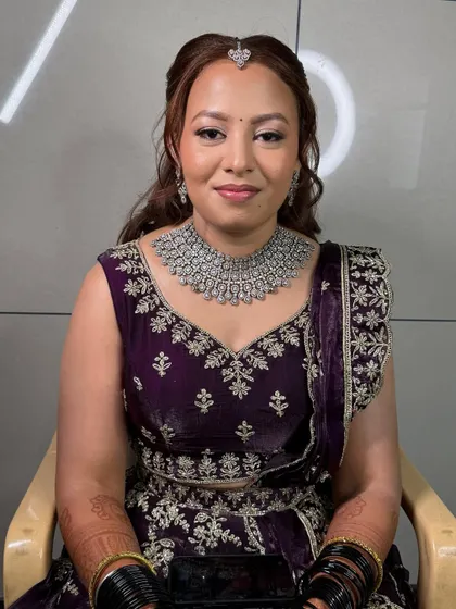 A smiling shot of Meghana. Her glass skin makeup is the star of this look.