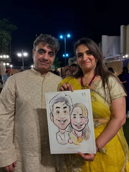 A couple holding their caricature at an outdoor evening event. Live art adds a unique and engaging element to any party or wedding function.