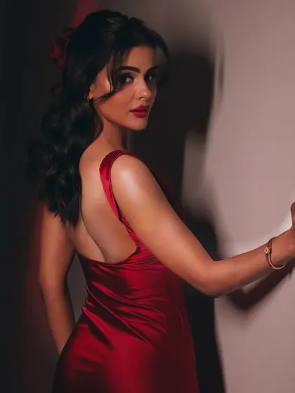 A beautiful backless dress moment. The hairstyle is a soft, romantic updo that perfectly complements the outfit.