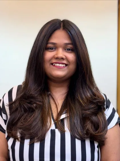 A smiling client happy with her new Mocha Musses hair. It's a subtle trend that makes a big impact.