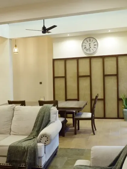 The dining area is defined by a unique, custom-designed partition wall, creating a sense of separation without closing off the space entirely.