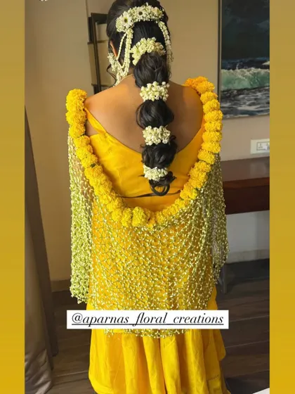 For a vibrant Haldi or Mehendi look, I create floral dupattas and chaddars. This piece features a net of delicate white flowers bordered with bright yellow marigolds, perfectly complementing the yellow ceremony attire.