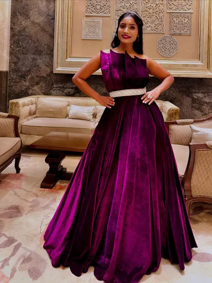 A client looking absolutely radiant in the magenta velvet gown. This photo shows how the rich fabric and bold color can make anyone feel classy and sassy for their special event.